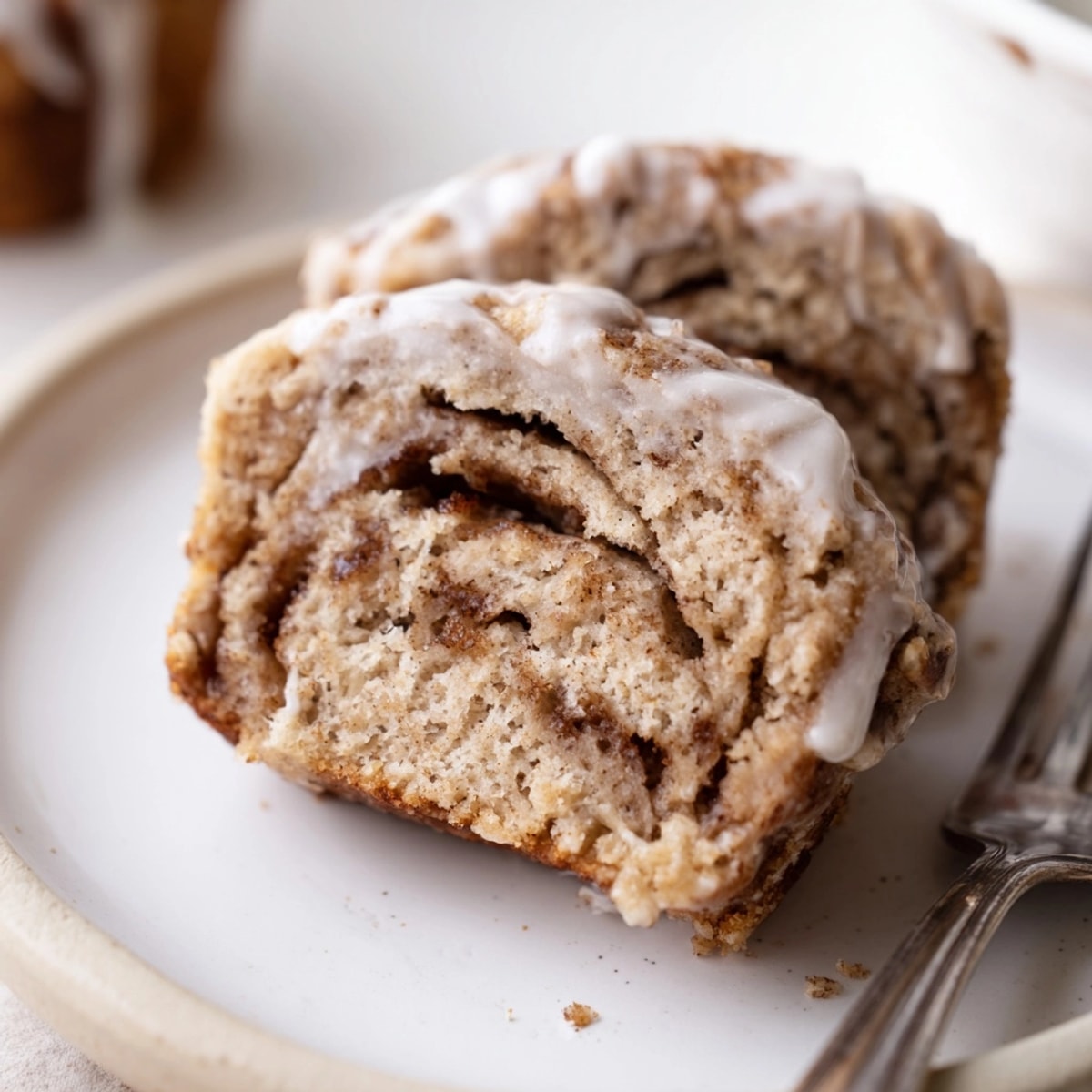 Golden Cinnamon Roll Protein Muffins, warm from oven, soft texture visible, ready for glaze.