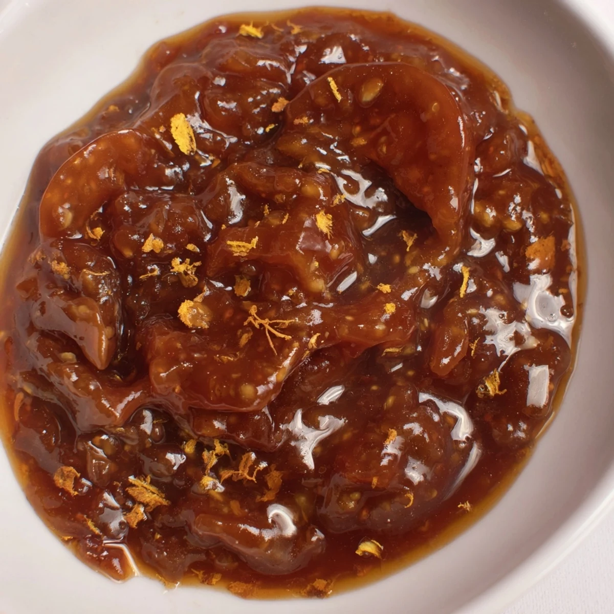 Close-up of bubbling spiced fig jam, capturing the rich aroma of cinnamon and cloves in the cooking process.