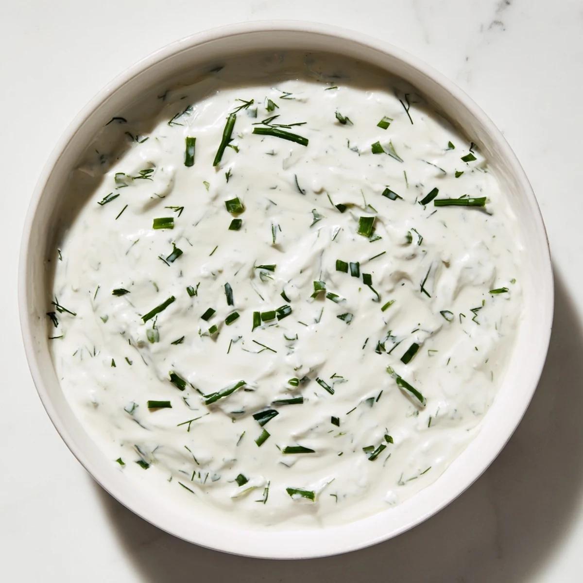 Homemade creamy ranch dressing, swirled lusciously in a bowl, perfect for dipping fresh veggies.