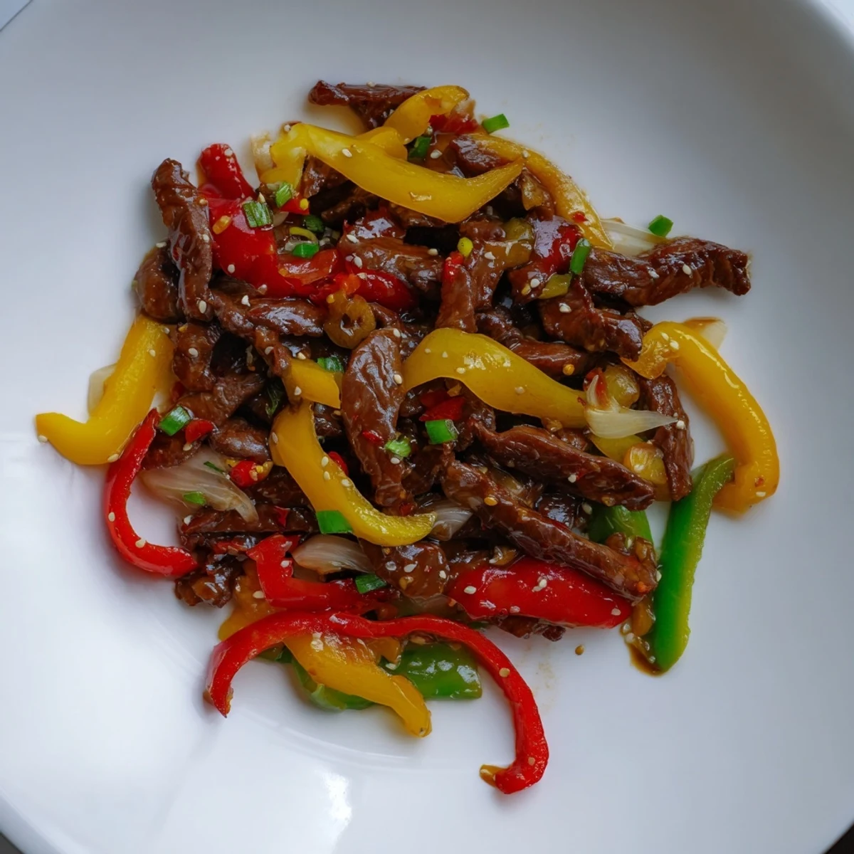 A steaming plate of homemade Szechuan Beef, glistening with a savory, spicy sauce and beef.