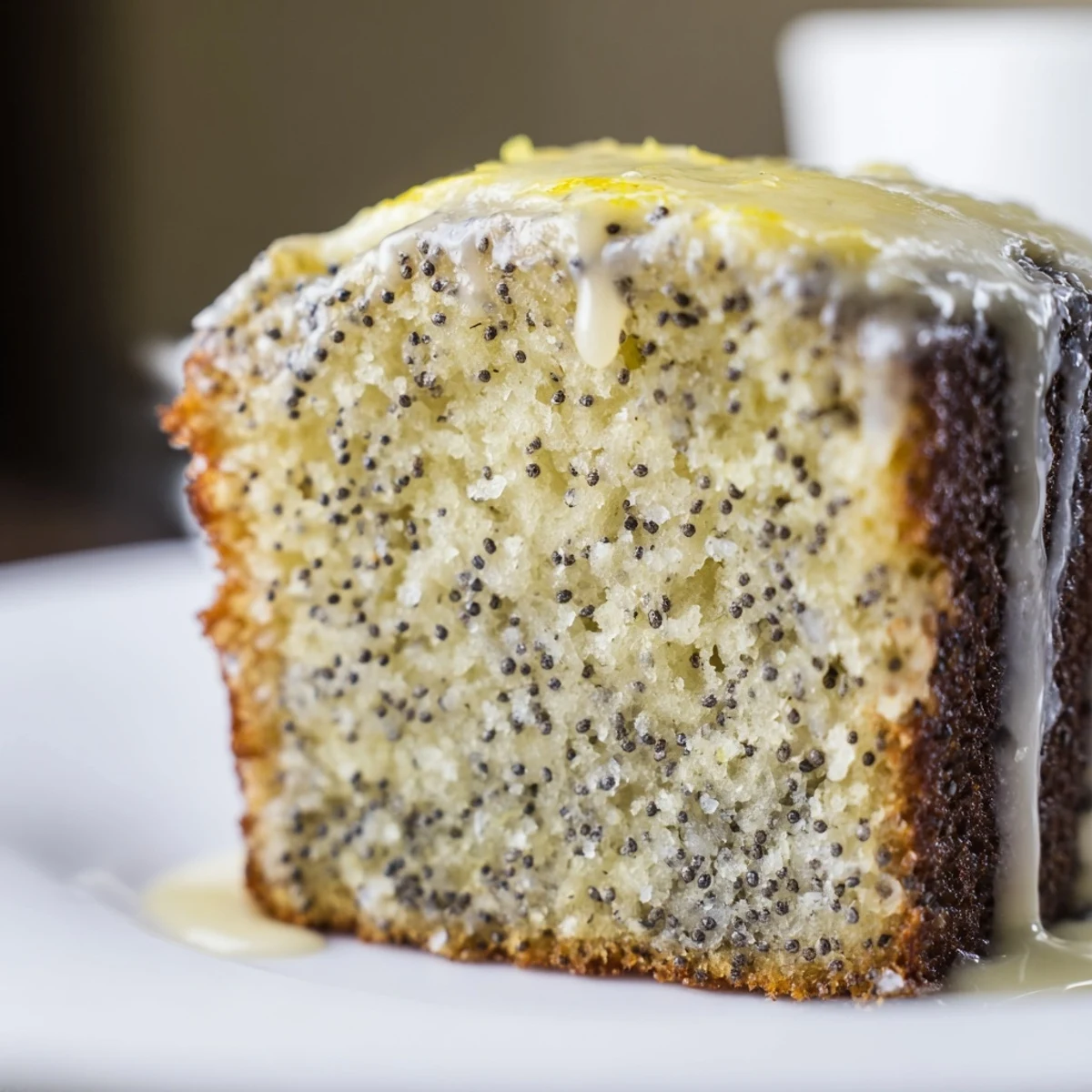 Golden-brown Poppy Seed Cake, its moist crumb promising a delightful, citrus-infused treat.