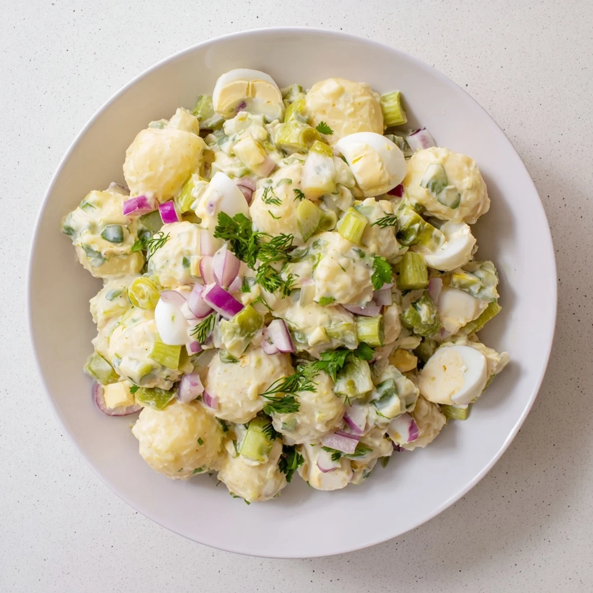 Enjoy the tangy, homemade potato salad, a classic side dish perfect for any occasion.