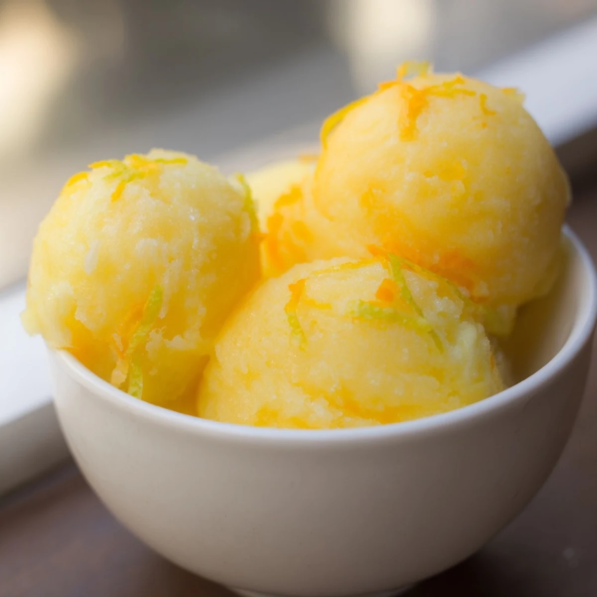 A close-up shot of refreshing citrus sorbet, perfect for a summer dessert, vegan-friendly.