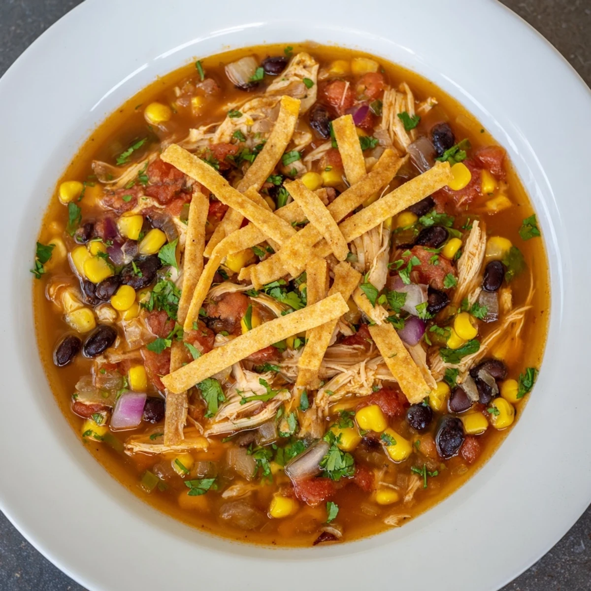Hearty Chicken Tortilla Soup is full of tender chicken, vibrant tomatoes, and savory spices.