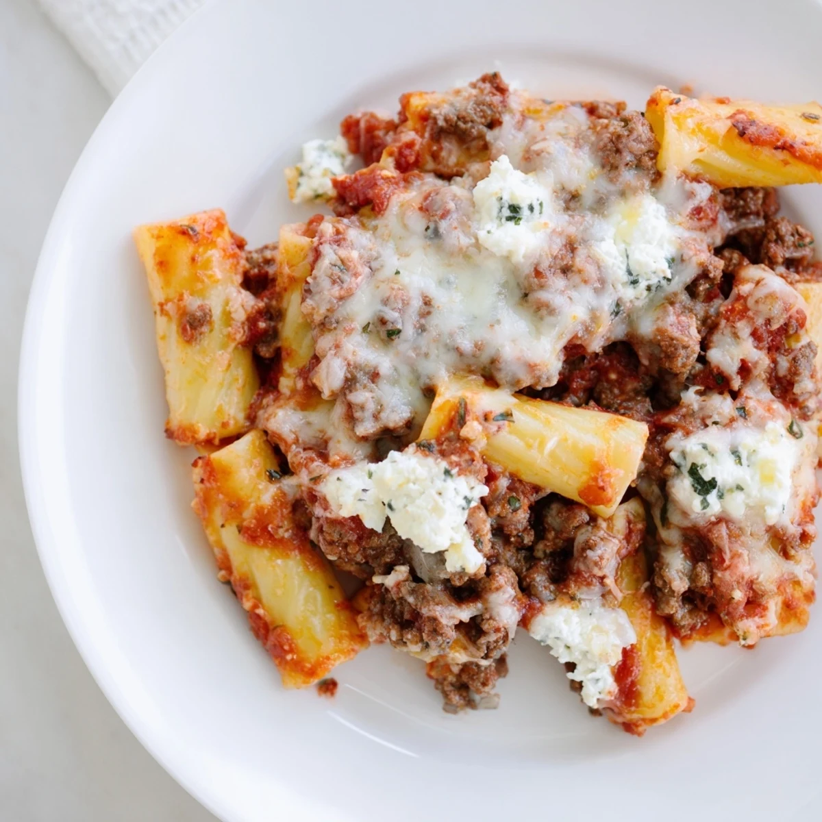 Baked Ziti with melted mozzarella, bubbling marinara, and a golden, bubbly cheese top ready to serve.
