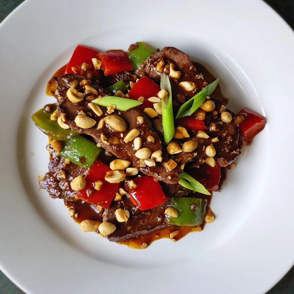Sizzling Spicy Kung Pao Beef with peanuts, a delicious Chinese stir-fry ready to enjoy.