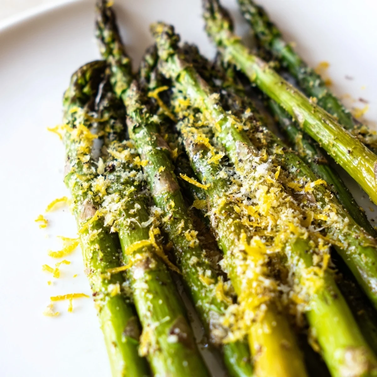 Tender roasted asparagus with Parmesan and lemon zest, served warm as a classic Mediterranean side dish for dinner.