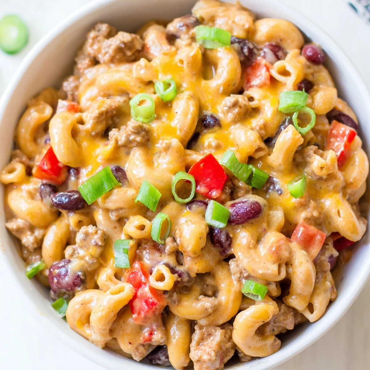 Steaming bowl of Turkey Chili Mac and Cheese with melted cheddar and fresh cilantro garnish.