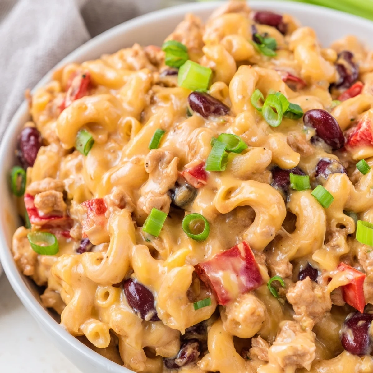 Spoonful of creamy Turkey Chili Mac and Cheese, revealing tender pasta and savory turkey meat.