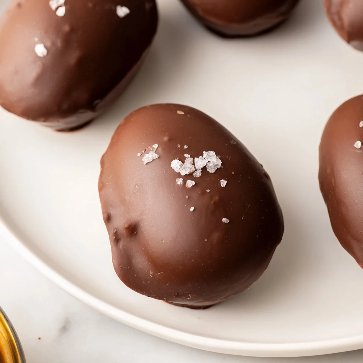Golden-brown homemade chocolate peanut butter eggs arranged on a baking sheet, ready to chill and set for a perfect Easter treat.  
