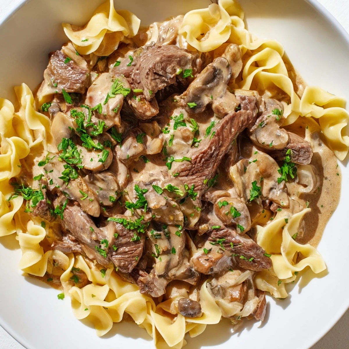 A comforting beef Stroganoff served over egg noodles with rich, savory mushroom gravy.