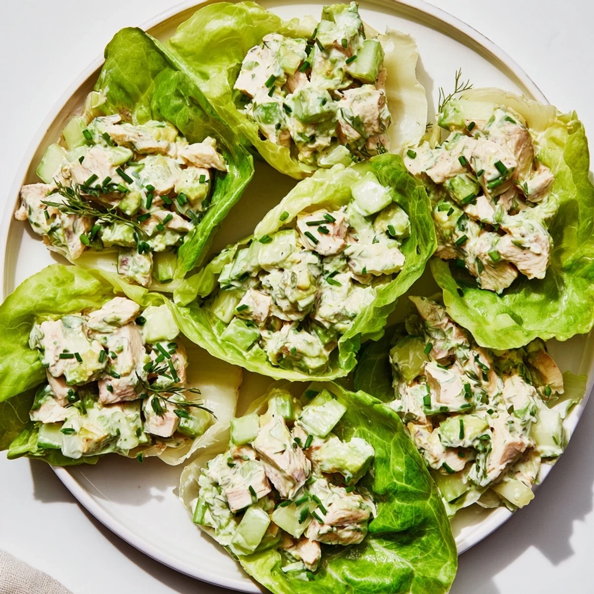 Savory Green Goddess Chicken Salad Lettuce Wraps garnished with chives, perfect for a light gluten-free dinner.