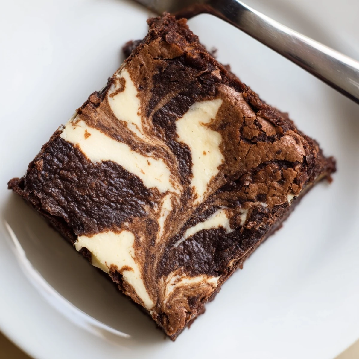 A close-up view shows moist, fudgy Cottage Cheese Brownies cut into squares with a chocolate drizzle.