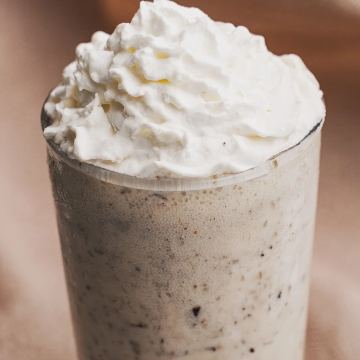 Creamy Starbucks Vanilla Bean Frappuccino topped with whipped cream in a tall glass, perfect for a refreshing summer treat.