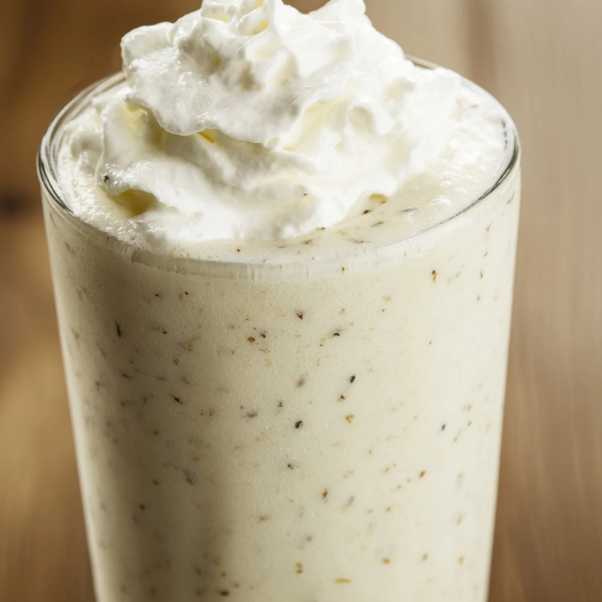 Starbucks Vanilla Bean Frappuccino in a frosty glass, topped with fluffy whipped cream, ideal for an indulgent afternoon pick-me-up.