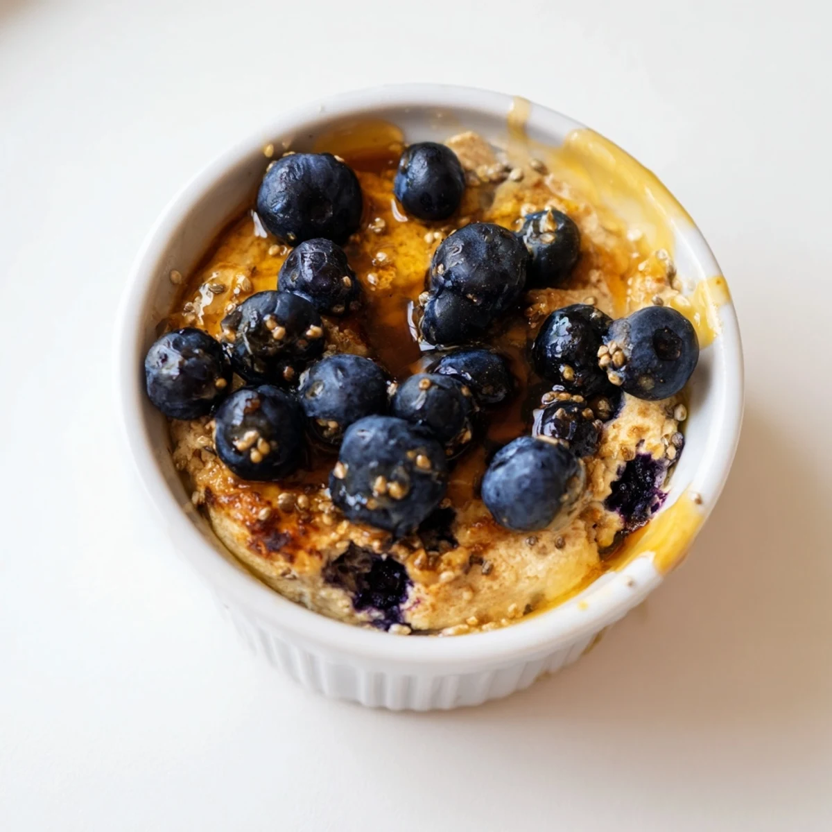 Golden-brown Baked Blueberry Cottage Cheese Breakfast Bowls emerge from the oven, showcasing bubbly blueberries and a creamy, protein-rich texture.