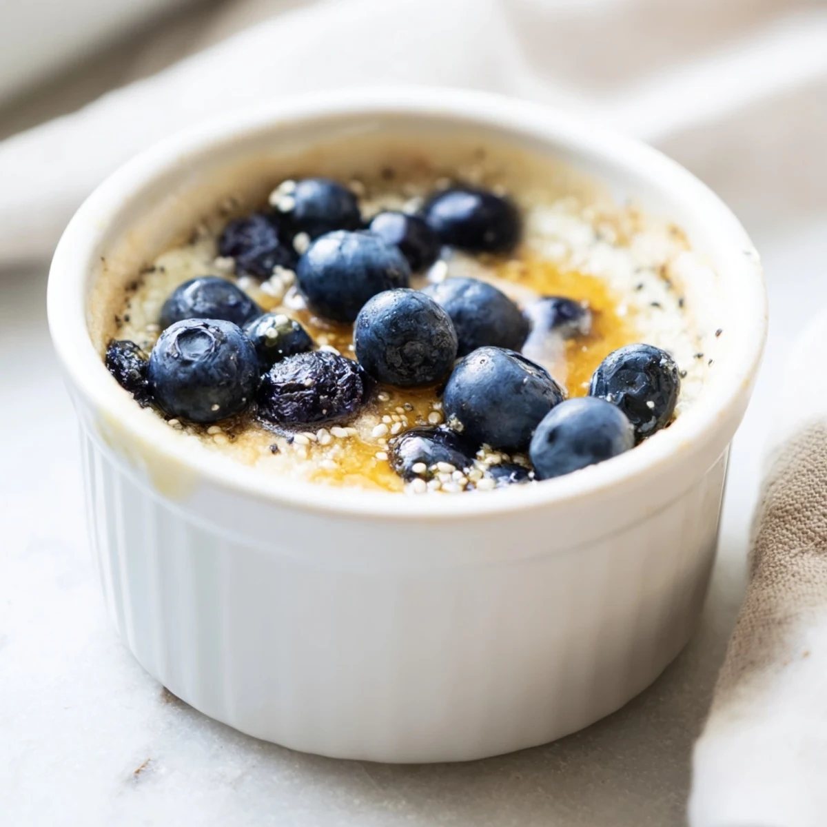 Freshly baked Baked Blueberry Cottage Cheese Breakfast Bowls in ramekins, featuring a hint of vanilla and lemon zest for a comforting start.