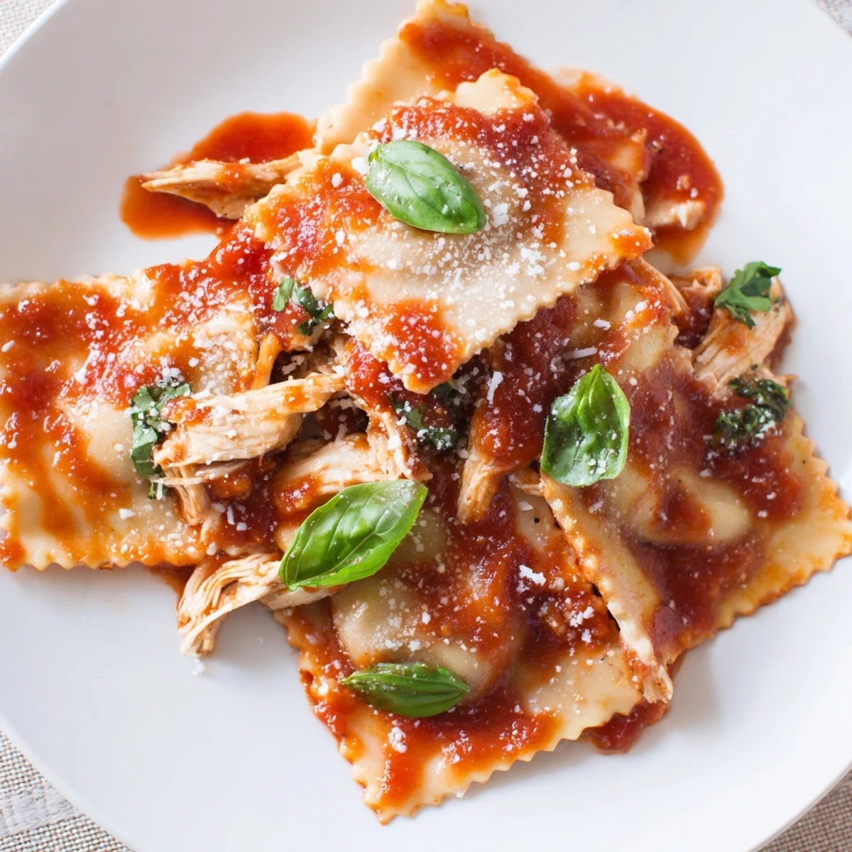 Freshly cooked Chicken and Mushroom Ravioli in a bowl with vibrant tomato sauce, ready to be served for dinner.