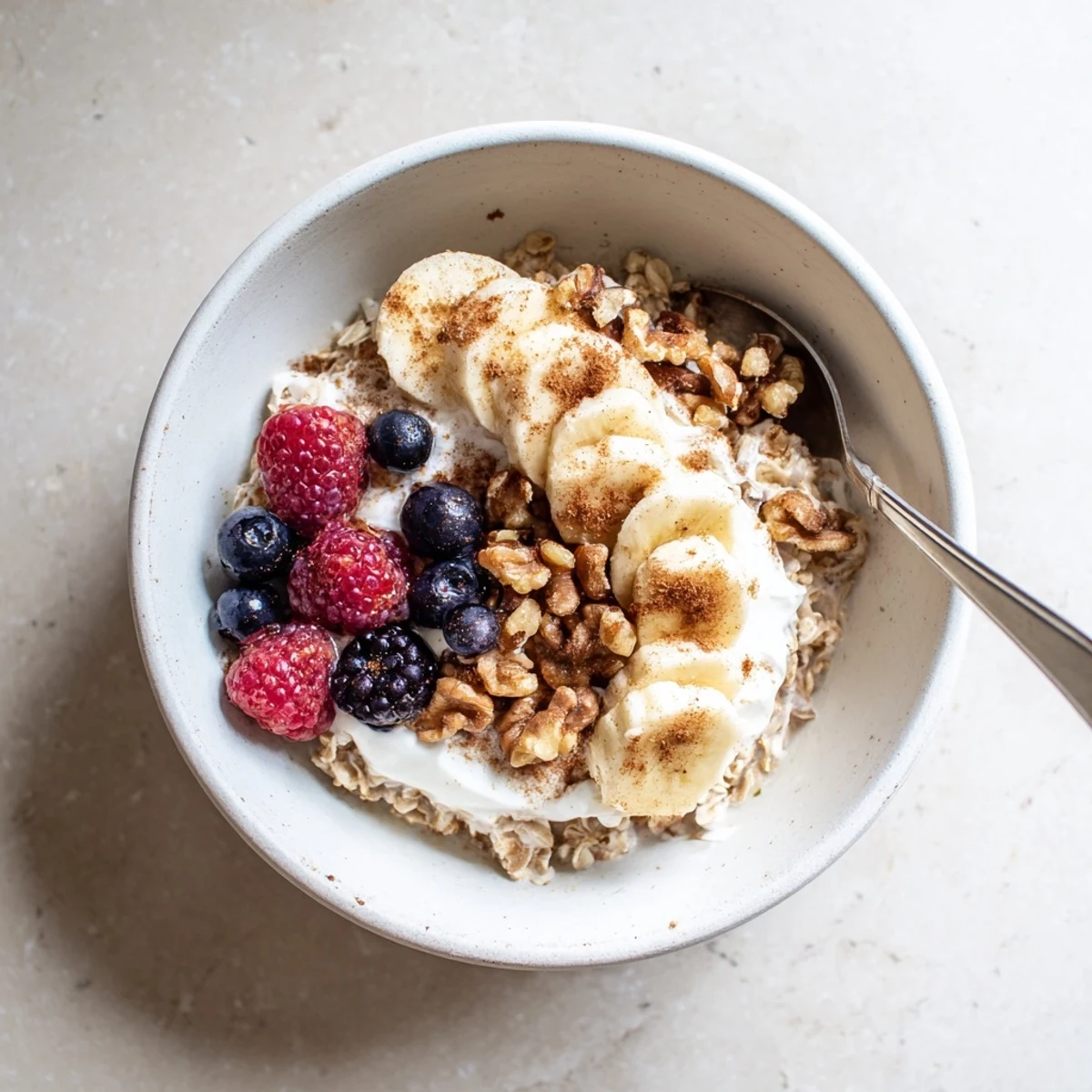 Wholesome brown sugar overnight oats with cinnamon swirled through layers of Greek yogurt and milk