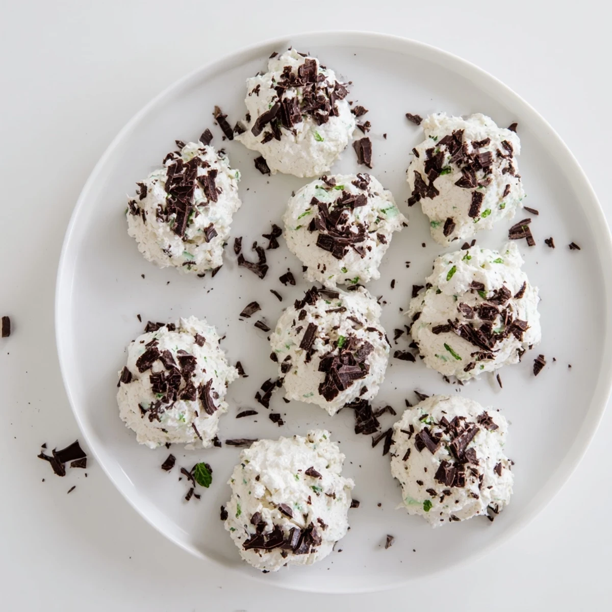 Dark chocolate and mint chip clouds meringue cookies baked until golden and crisp on parchment paper