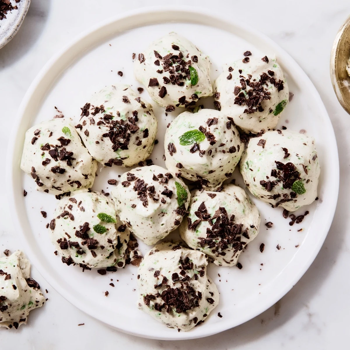 Fluffy dreamy dark chocolate and mint chip cloud cookies dotted with green mint chips ready for serving