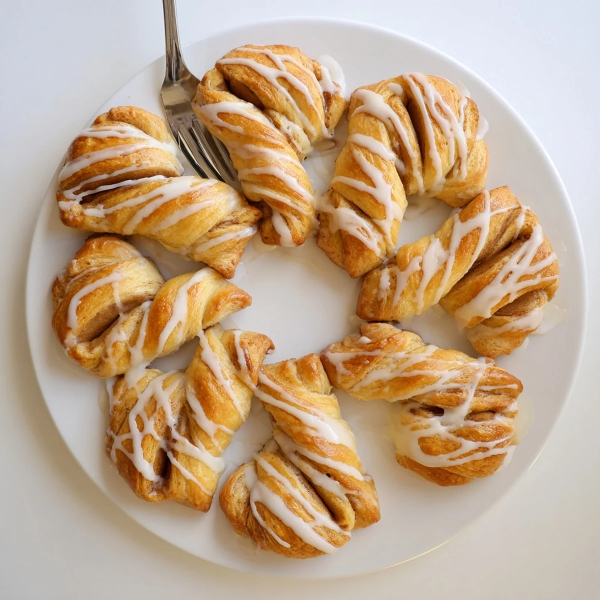 Warm breakfast twists topped with sweet vanilla icing and cinnamon sugar layers
