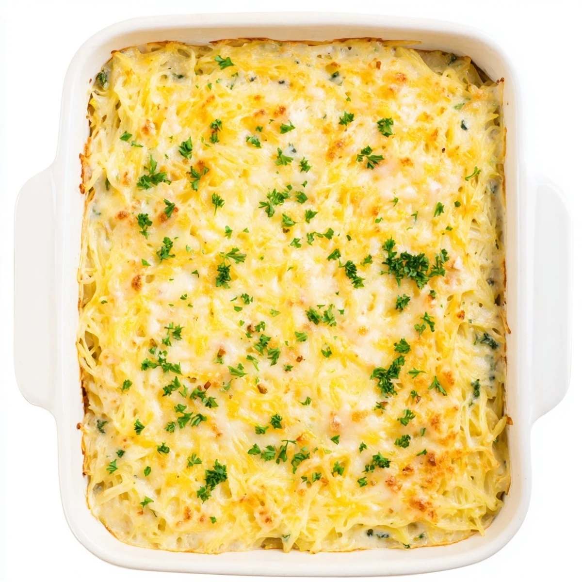Creamy low-carb spaghetti squash au gratin casserole with bubbly cheese crust and parsley garnish