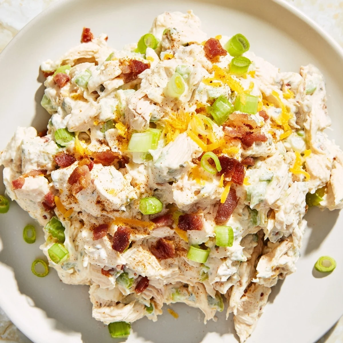 Spoonful of spicy jalapeno popper keto chicken salad served in lettuce cups with celery sticks