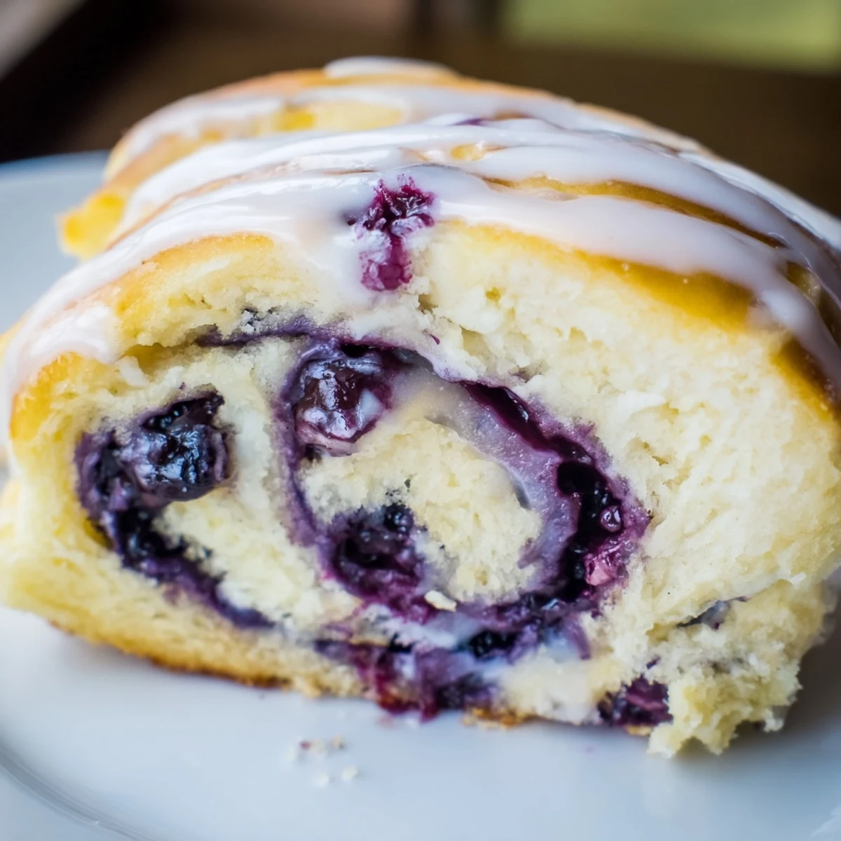 Golden spiral pastry filled with sweet blueberries and zesty lemon, topped with lemon icing