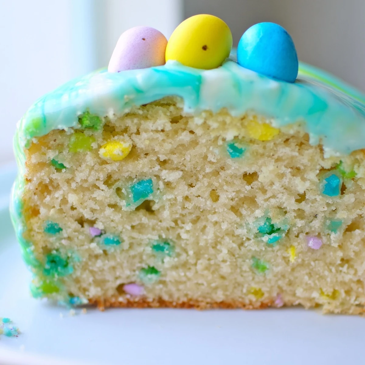 Tender vanilla Robin Egg Snack Cake studded with colorful candy-coated chocolate malted eggs
