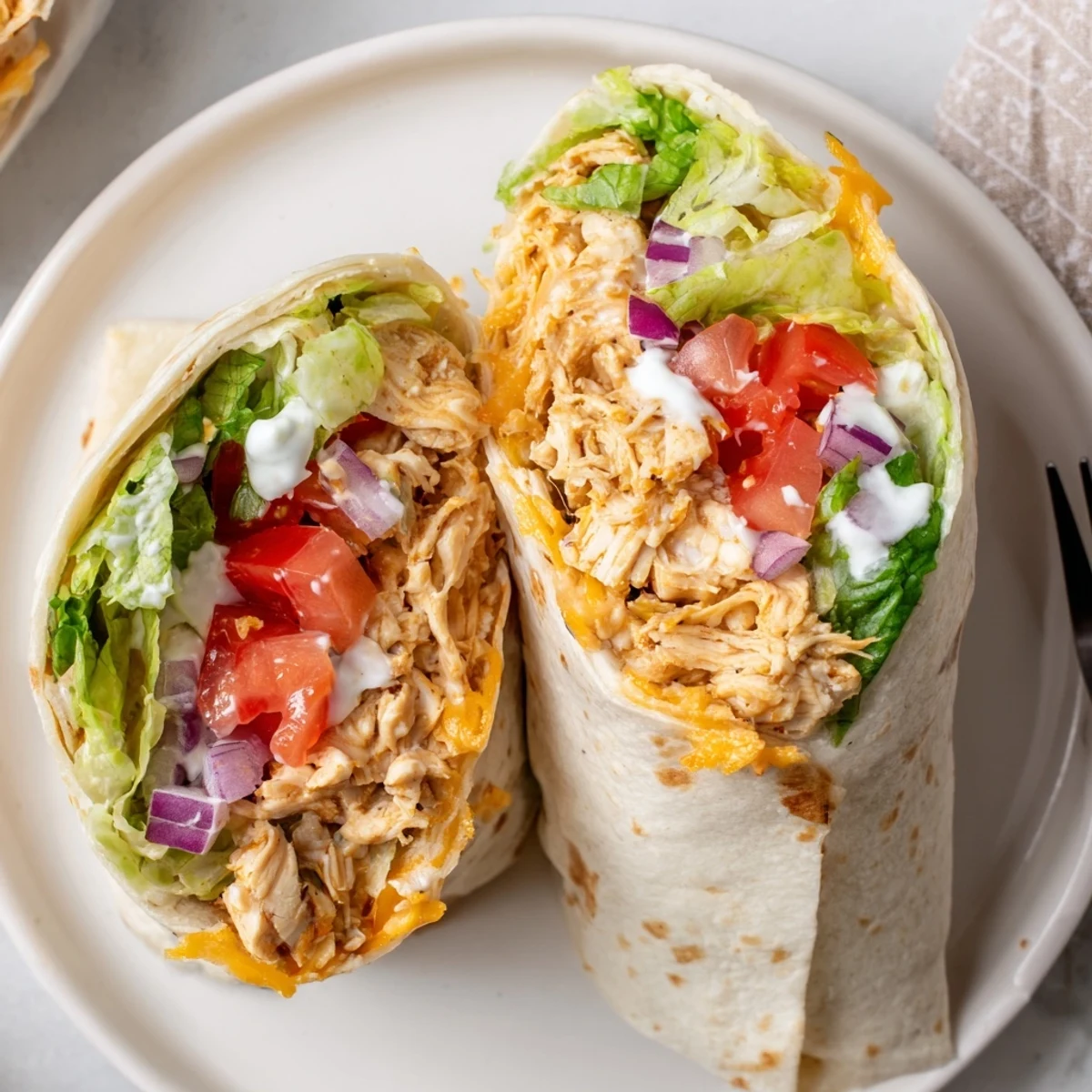 Cheesy Garlic Chicken Wraps with melty cheddar, warm tortilla and crisp lettuce