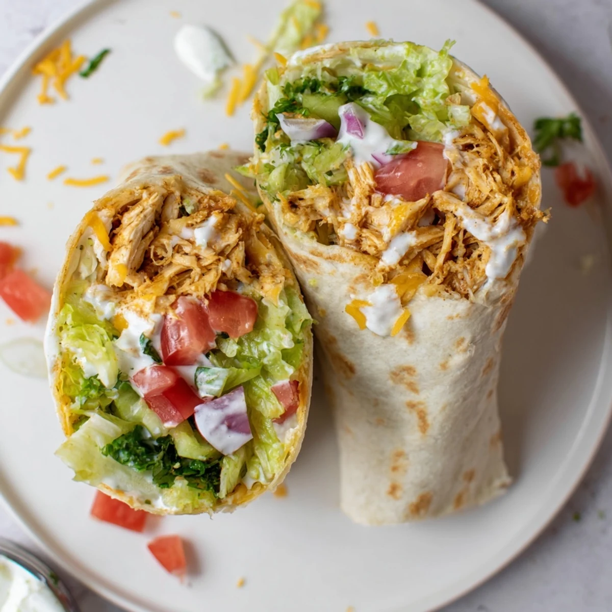 Pan toasted Cheesy Garlic Chicken Wraps served with tangy parsley sauce, tomato bites