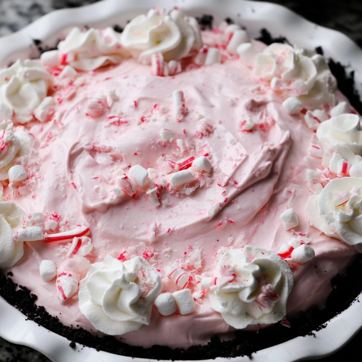 No-bake Candy Cane Pie chilled in fridge, pink swirls and marshmallow bits