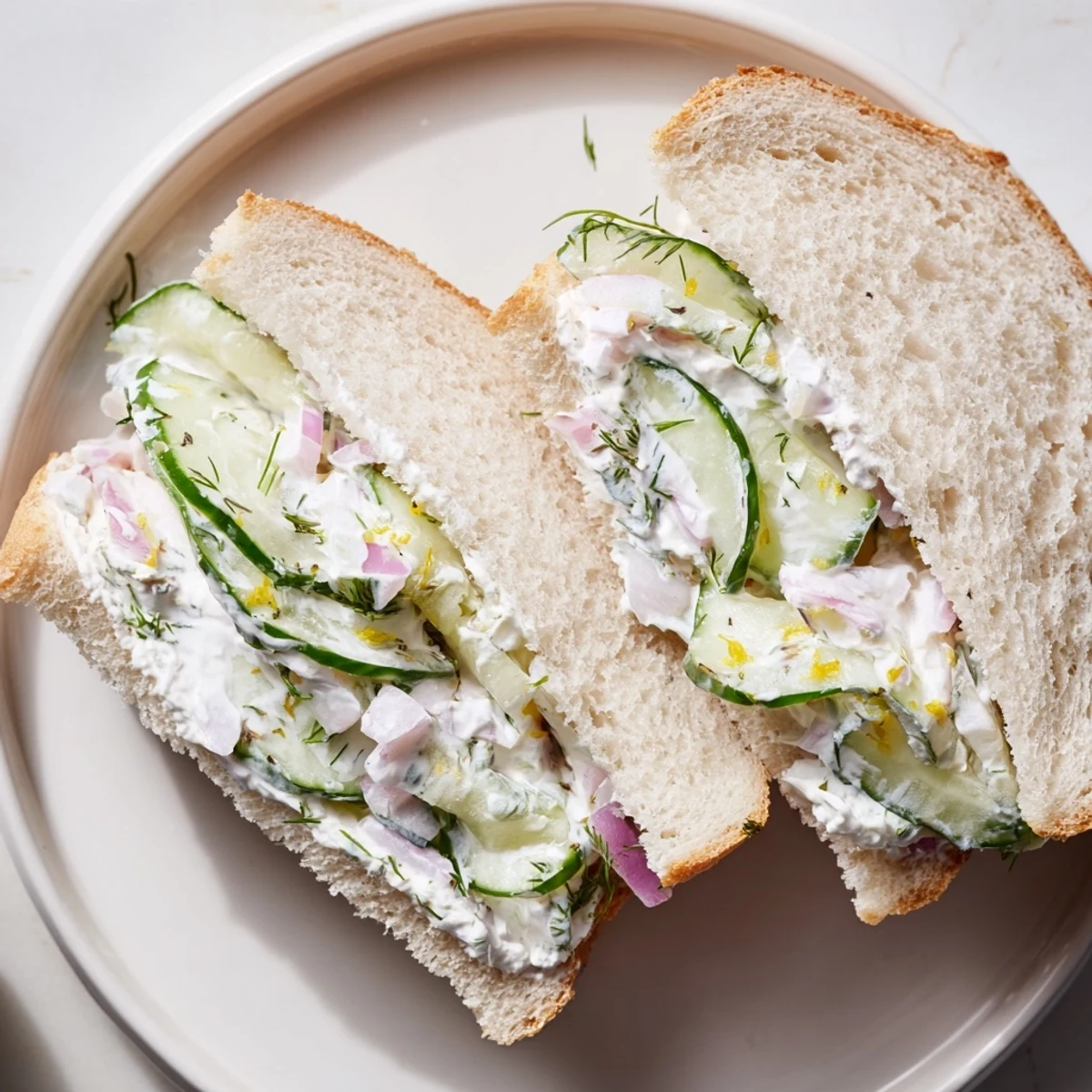 Chilled Quick Cucumber Salad Sandwiches cut in halves, dill aroma and creamy tang.