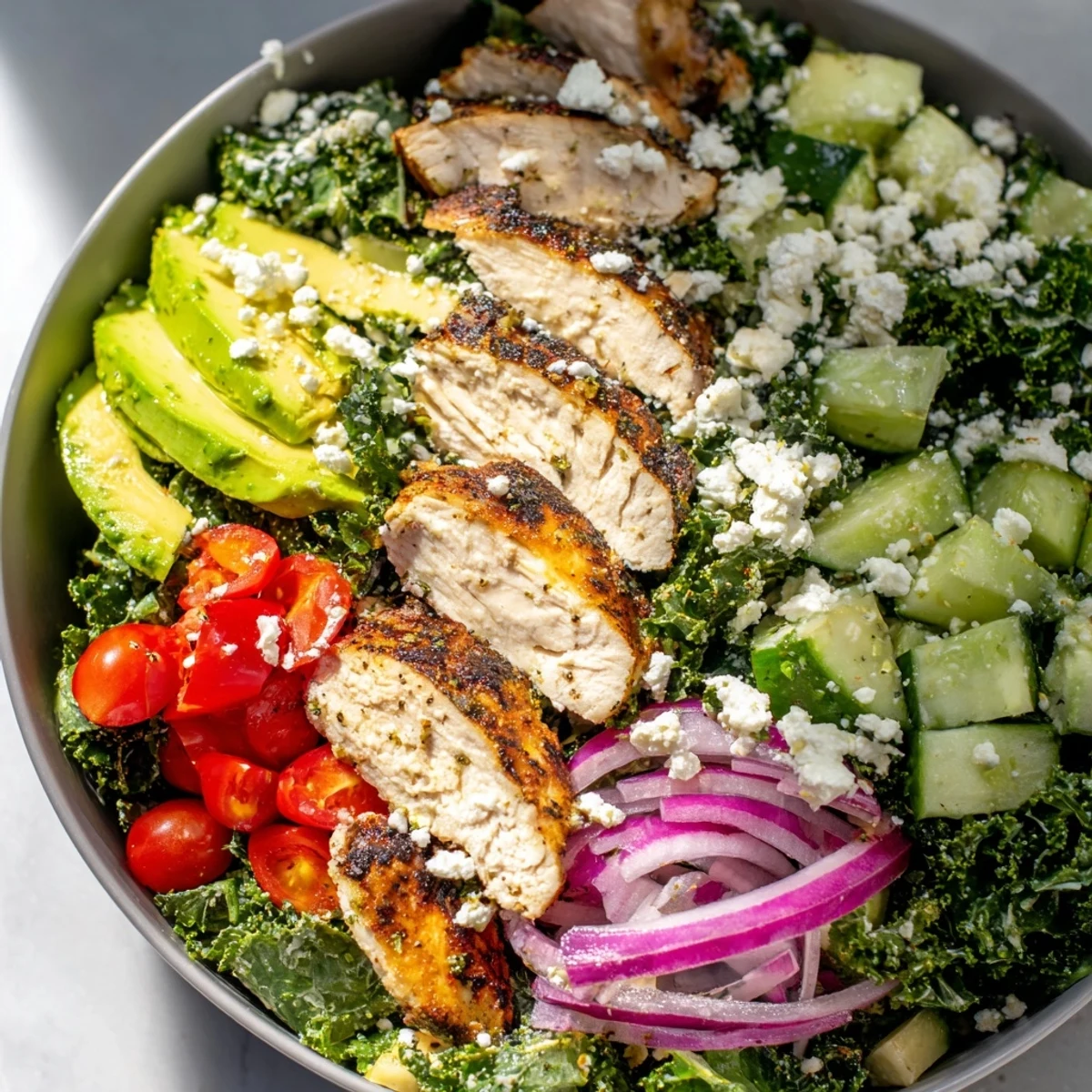 Wholesome marinated kale and chicken bowl featuring juicy sliced chicken and crisp vegetables