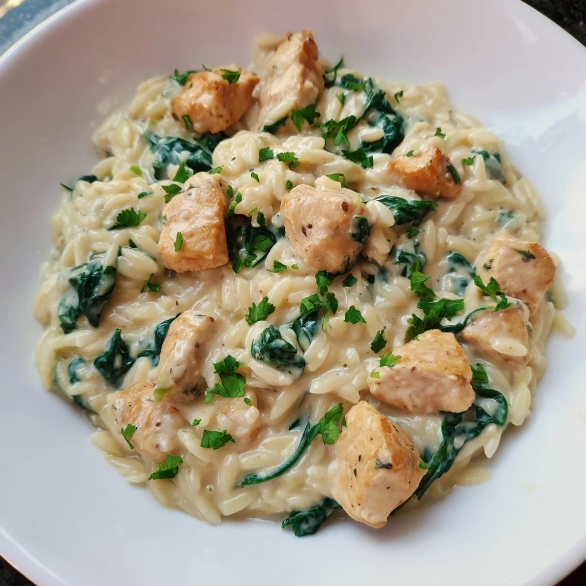 Golden one pan Boursin chicken orzo with spinach featuring creamy melted cheese sauce and tender pasta pieces