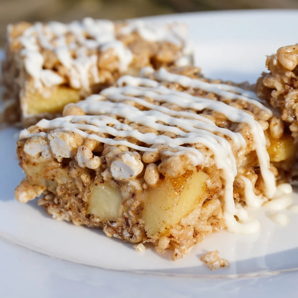 Gooey Apple Pie Rice Krispie Treats with caramelized apple chunks and white chocolate drizzle
