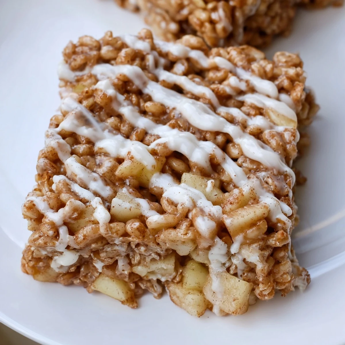 Chewy Apple Pie Rice Krispie Treats square topped with sweet melted white chocolate