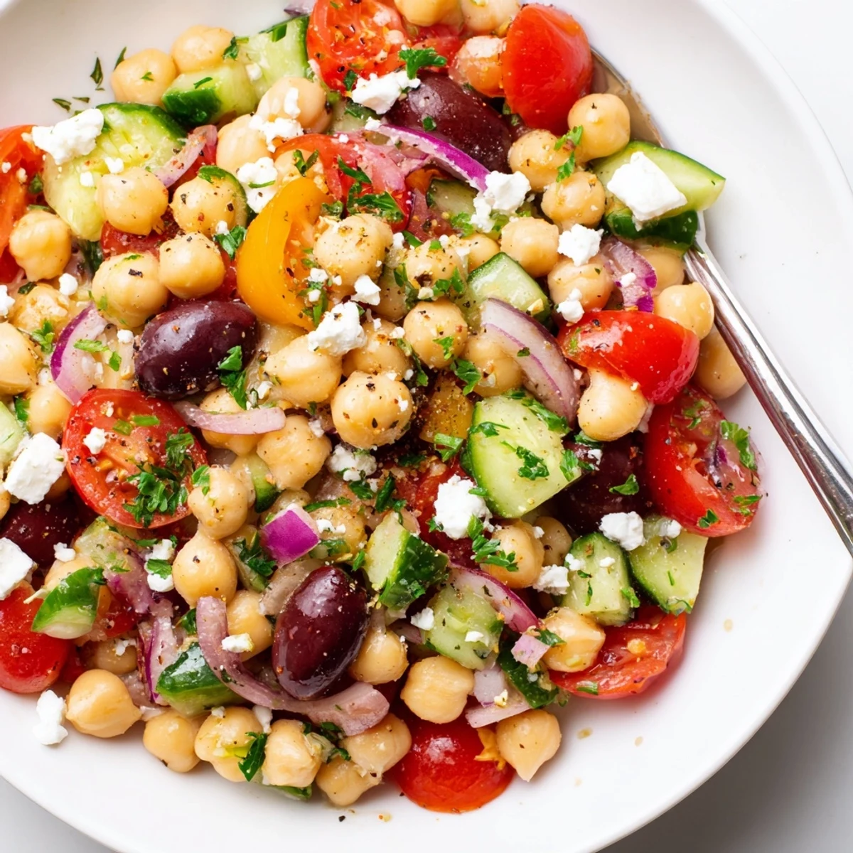 Chilled Mediterranean Chickpea Salad served in a bowl with Kalamata olives and parsley