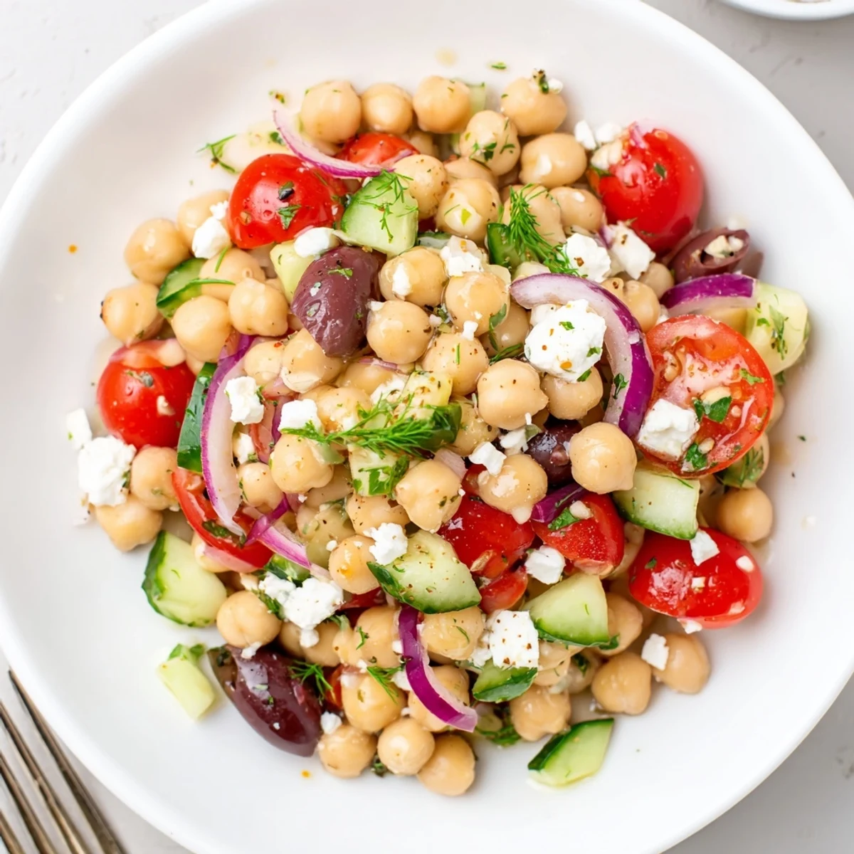 Mediterranean Chickpea Salad bursting with cherry tomatoes, cucumber, and lemon dressing