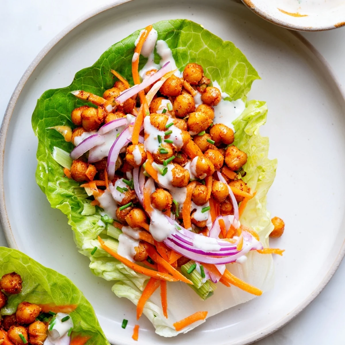 Buffalo Chickpea Lettuce Wraps with spicy golden chickpeas, crisp carrots, creamy ranch.