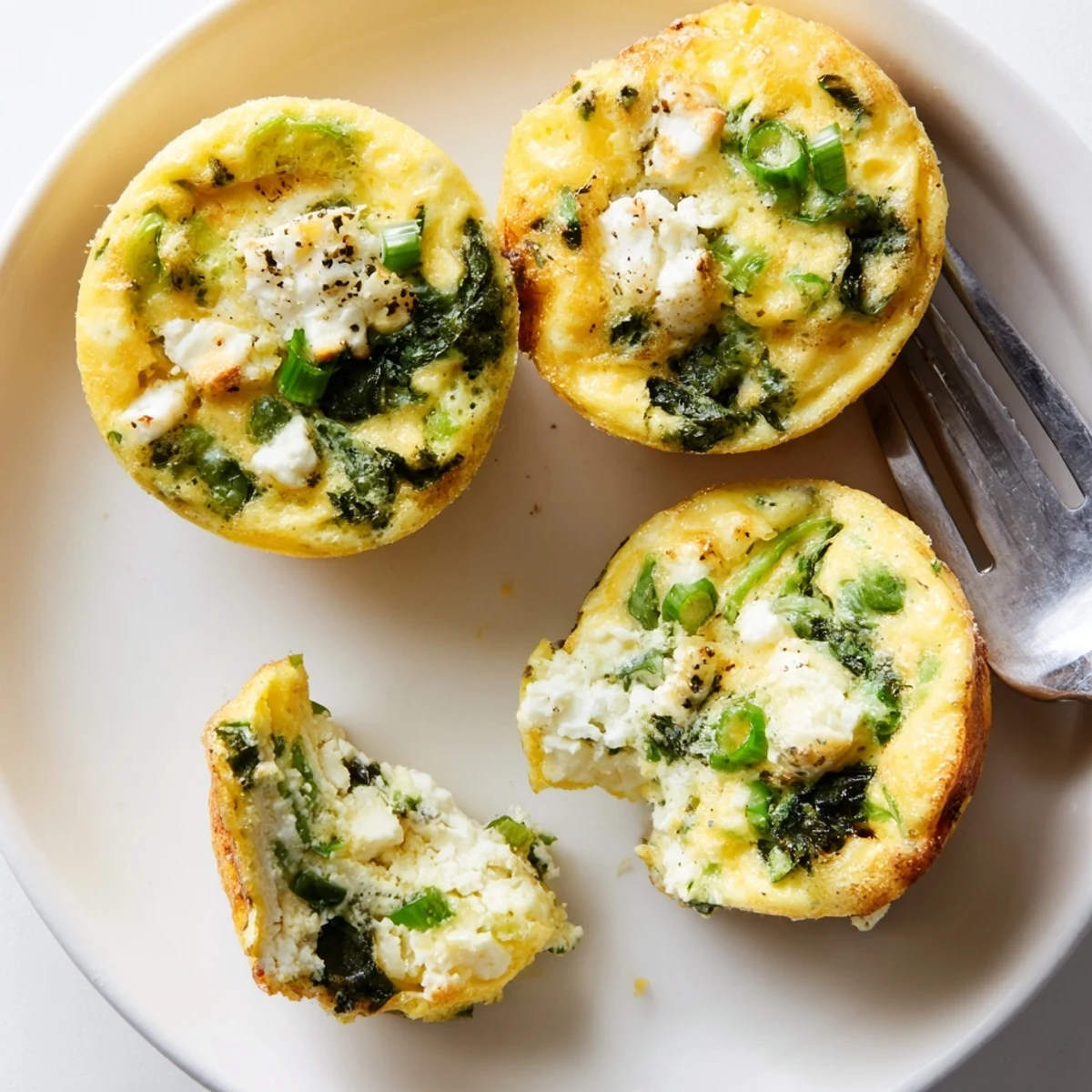 Plate of Savory Spinach Feta Egg Bites garnished with fresh tomato salsa