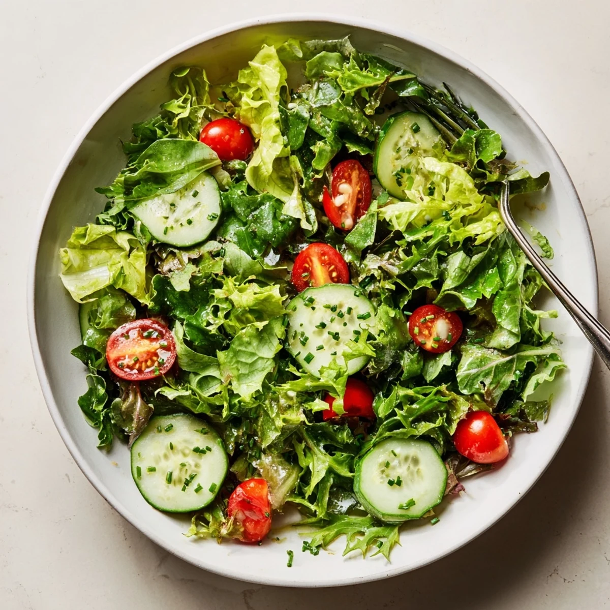 Simple Green Salad Recipe with crisp mixed greens, lemon vinaigrette glistening