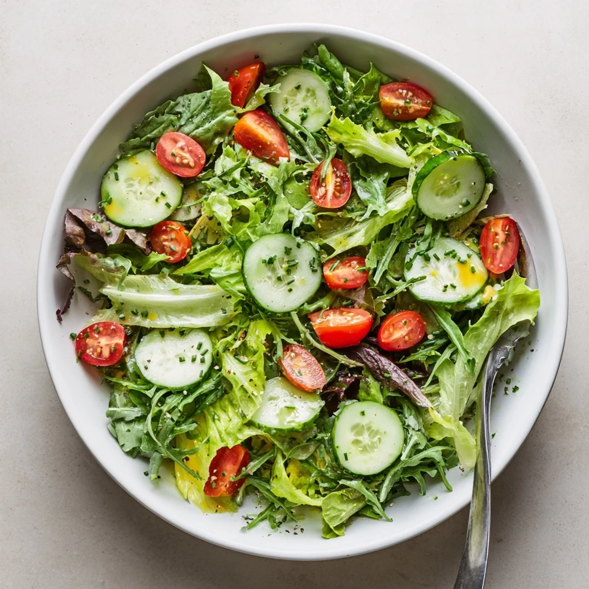 Bright Simple Green Salad Recipe tossed with cucumber, cherry tomatoes, fragrant herbs