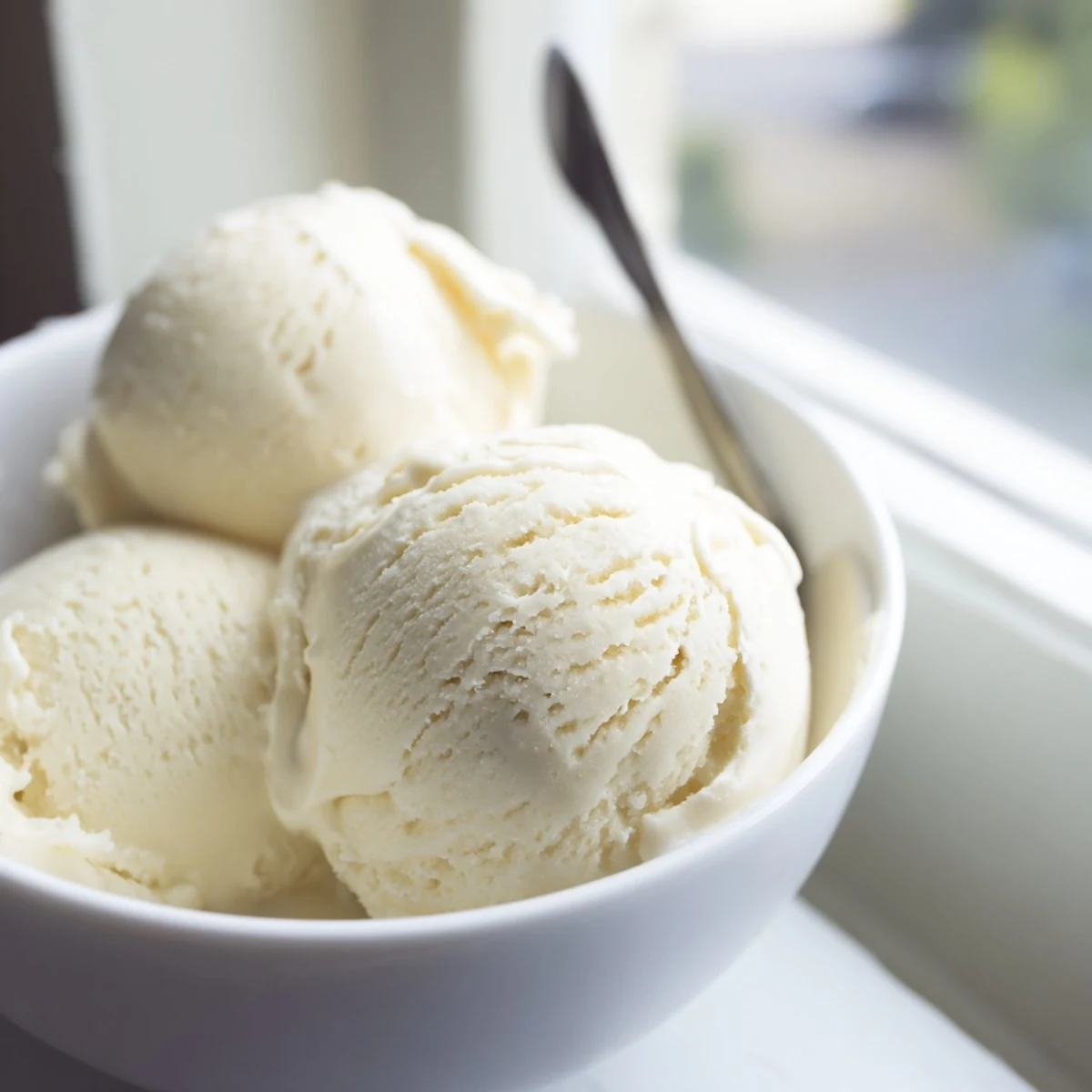 Rich vanilla ice cream being churned in an ice cream maker with a smooth custard texture