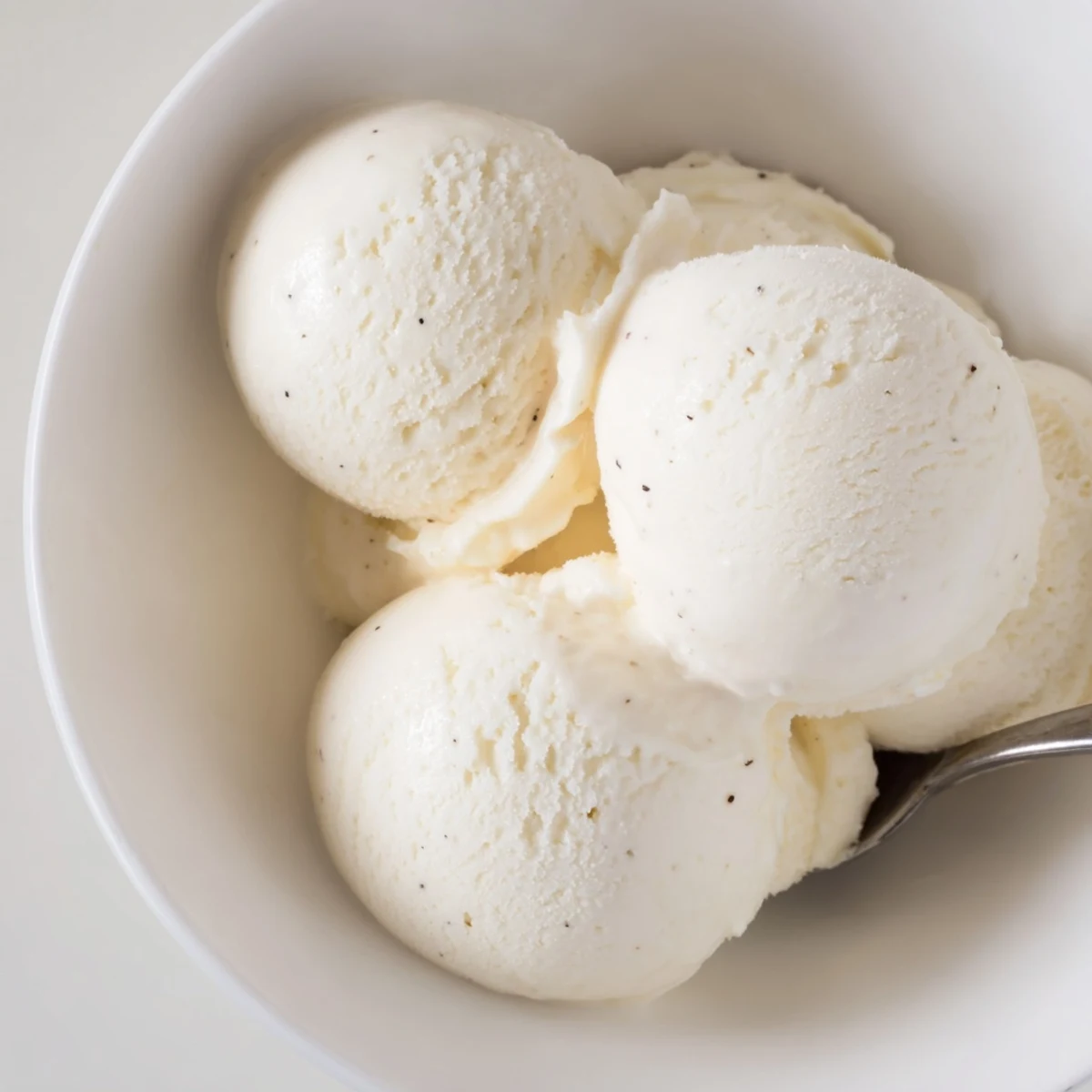 Classic vanilla ice cream recipe served in chilled bowls with whipped cream topping