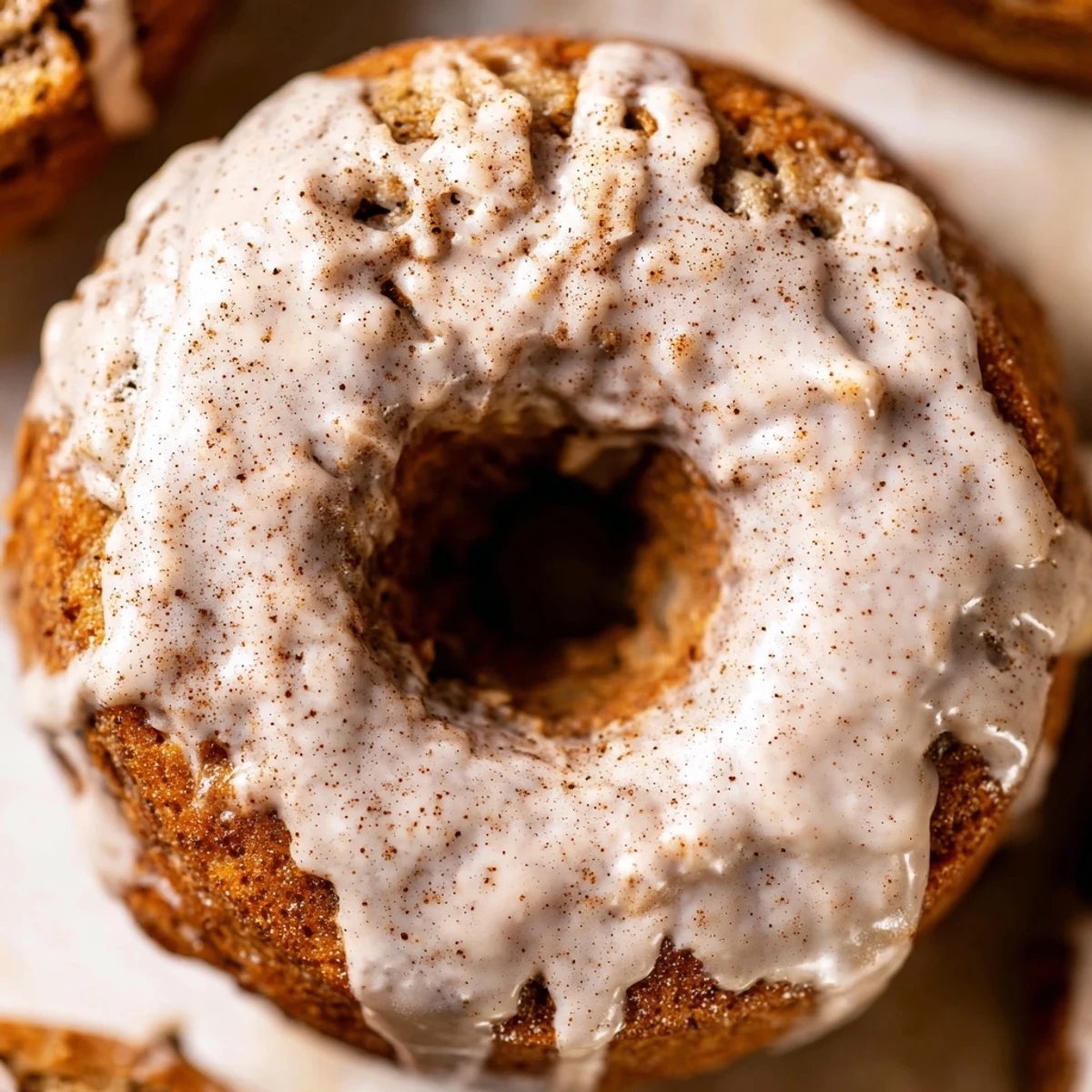 Homemade banana bread donuts with cinnamon sugar coating on white wire rack