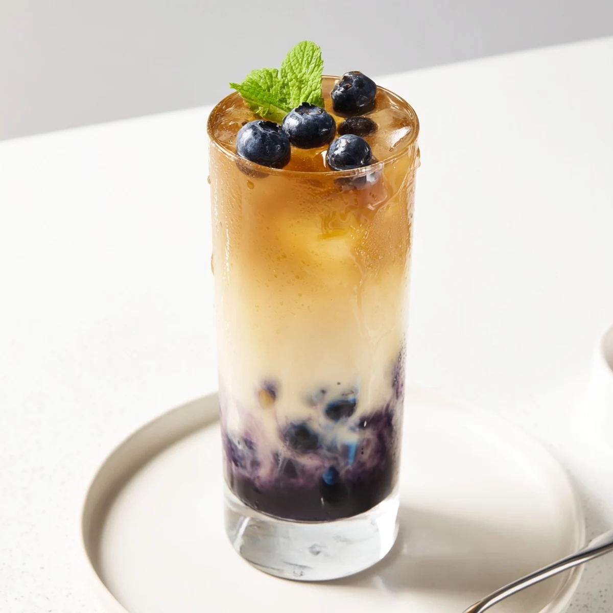 Chilled Blueberry Milk Tea Cooler showing creamy milk swirl and fresh blueberries
