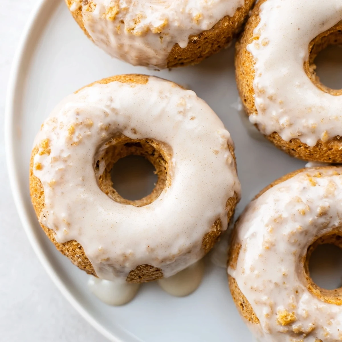 Moist banana bread donuts fresh from the oven with a crumbly texture and optional powdered sugar coating