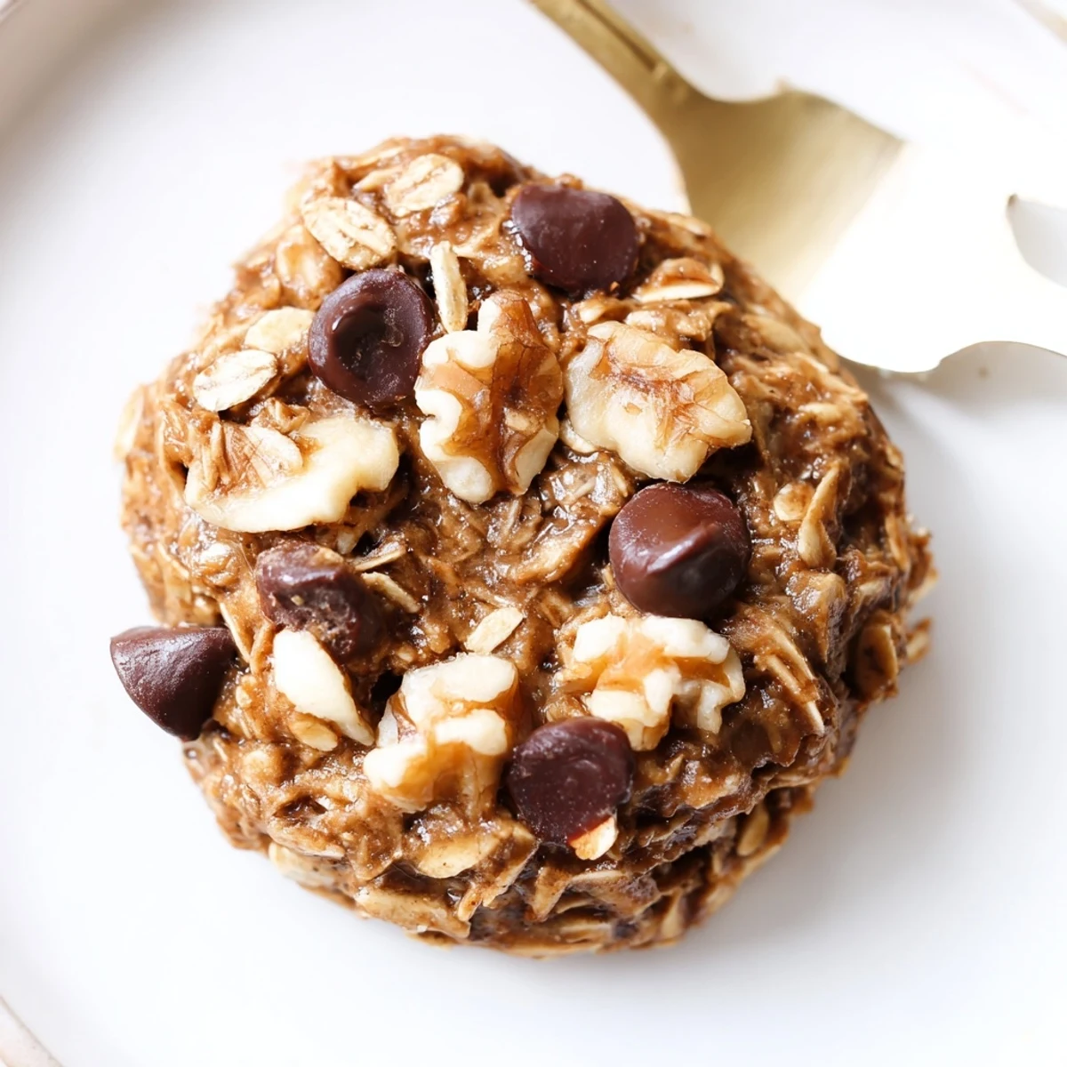 Soft, golden Banana Oat Cookies studded with chocolate chips, served with milk.